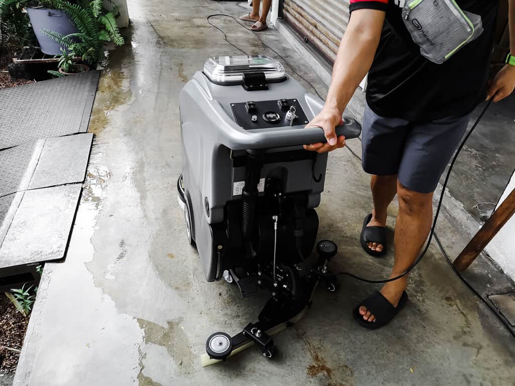 A tester is turning the latest Upekkha 5050 series walk behind / push scrubber dryer in Upekkha's premises.