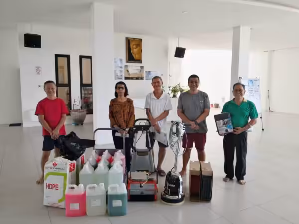 A few customers are smiling as they stand proudly behind their purchase of HDPE garbage bags, cleaning detergents, black floor scrubber machine and a red auto scrubber.