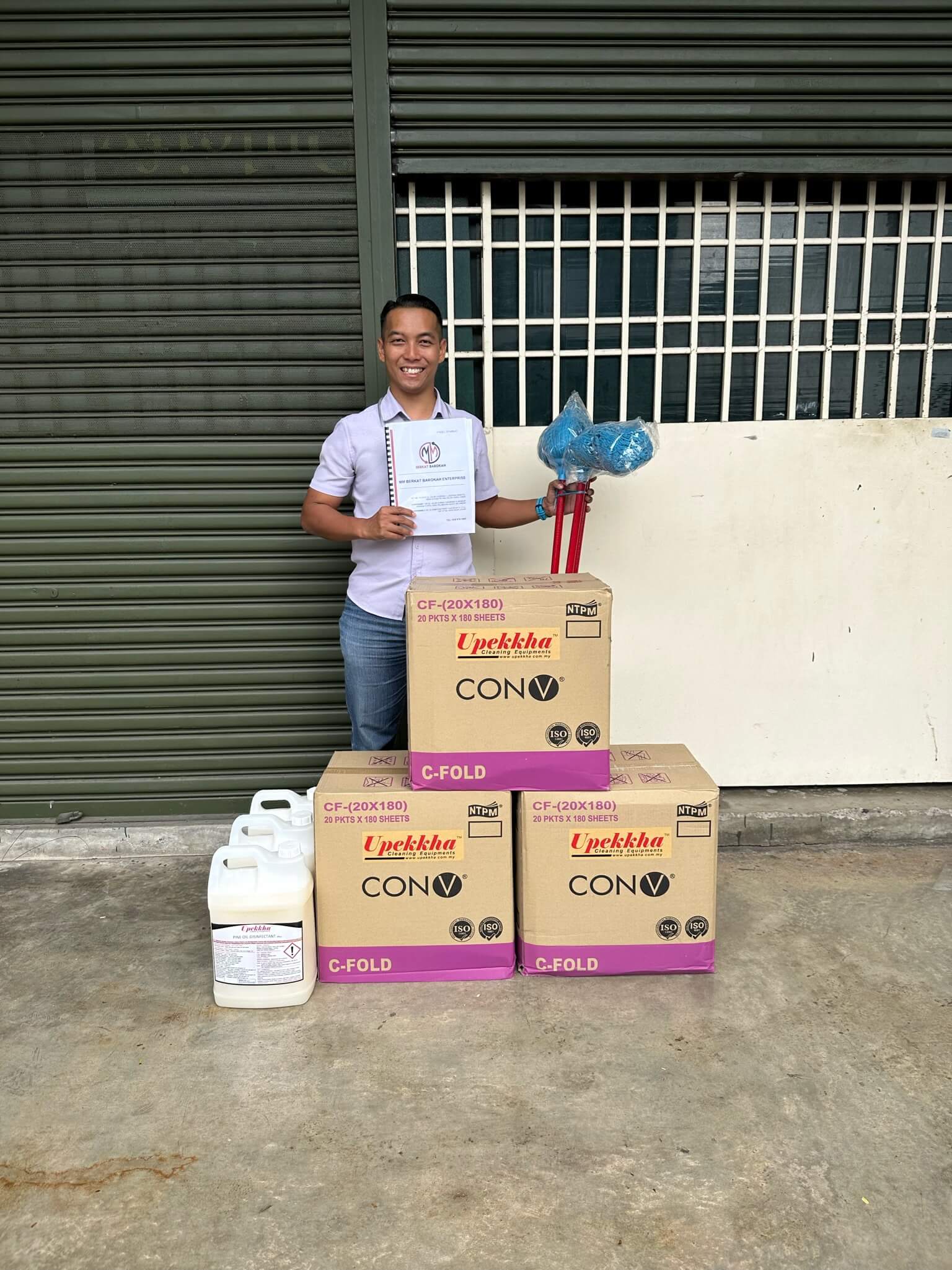 A smiling customer with his cleaning products purchase from Upekkha.