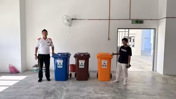 Two people with colorful trash bins