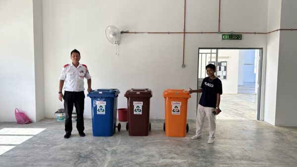Two people with colorful trash bins