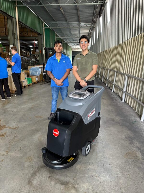 Two people and a Upekkha auto scrubber machine