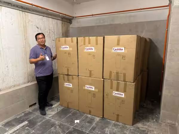 A man giving the thumbs up with his boxes of Upekkha bins