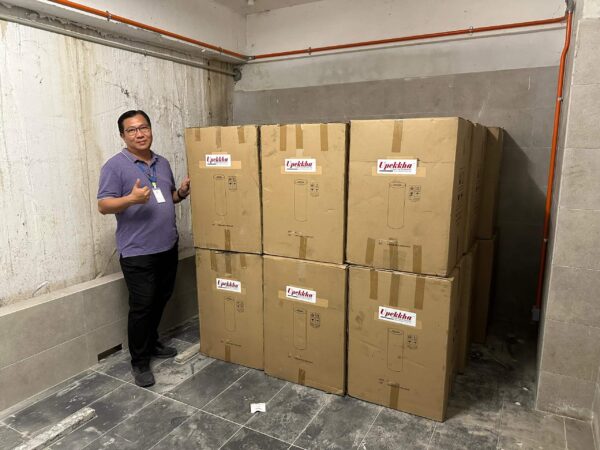 A man giving the thumbs up with his boxes of Upekkha bins